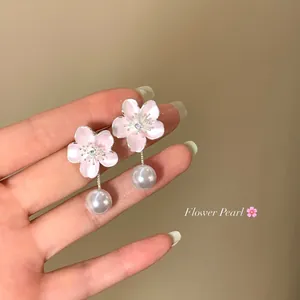 Detail of pink cherry blossom earrings with elegant pearl drop tassels