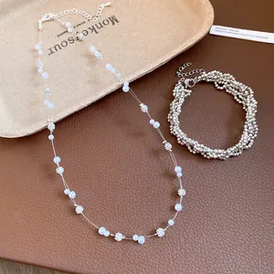 Close-up of elegant faux pearl necklace with rhinestone beads and a sparkling bracelet