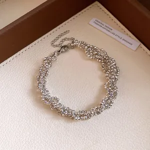 Detailed view of an elegant silver faceted beaded necklace with a secure lobster clasp