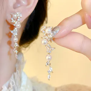 Elegant leaf tassel zircon and pearl ear clips for non-pierced ears, luxury gold finish.
