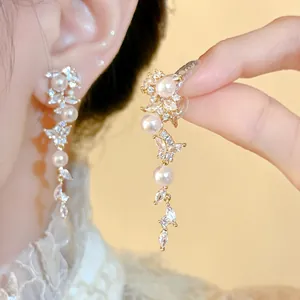 Detailed view of elegant leaf-shaped pearl tassel ear clips with cubic zirconia