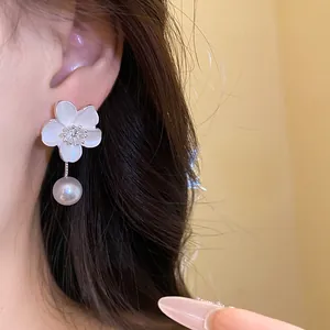 Elegant French vintage style flower earrings with pearl drop shown as a close-up detail