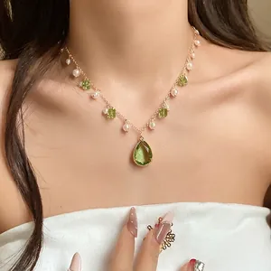 Vintage green teardrop pendant necklace with white pearls on a gold chain