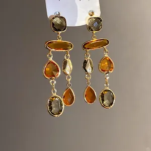 Detailed view of vintage Maillard color crystal drop earrings with geometric faceted stones.