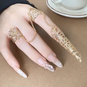 Detailansicht eines gotischen goldenen Fingerschutzes mit Hohlmuster und Ketten