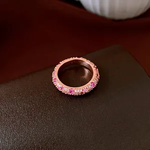 Elegant rose gold eternity ring featuring sparkling pink and white cubic zirconia stones