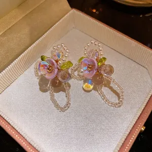 Elegant silver needle flower earrings with pearls and cat-eye stones in a gift box.