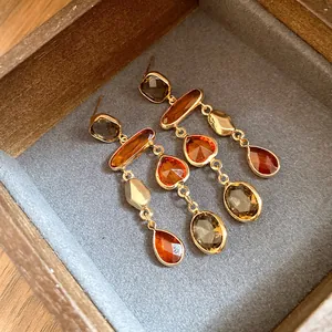 Close-up of vintage Maillard style crystal tassel earrings presented in a jewelry box
