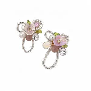 Elegant floral stud earrings with pearls and cat-eye stones in a delicate boutique style