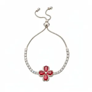Elegant silver clover bracelet featuring red zircons and an adjustable slider clasp