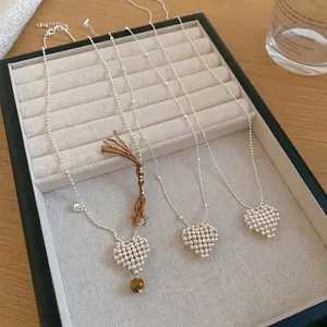 Elegant minimalist silver heart beaded pendant necklaces displayed on a jewelry tray.