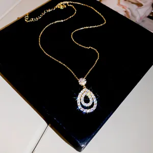 Detail of teardrop pendant necklace with sparkling cubic zirconia in gold finish
