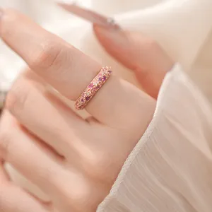 Close-up of elegant rose gold ring set with sparkling pink and purple cubic zirconia.