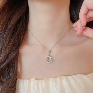 Close-up of elegant zircon water-drop pendant necklace on model's neck.
