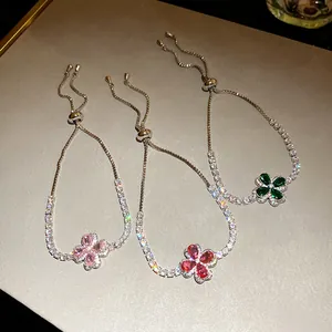 Three clover charm bracelets with colorful zircons and adjustable drawstring closures.