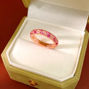 Close-up of elegant rose gold ring encrusted with pink and clear cubic zirconia stones