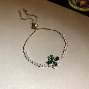 Close-up of adjustable bolo bracelet with green cubic zirconia four-leaf clover