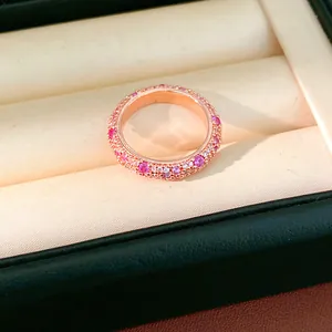Close-up of elegant rose gold ring paved with sparkling pink and white cubic zirconia