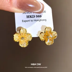 Elegant amber gradient clover earrings with textured crystal and gold-plated borders.