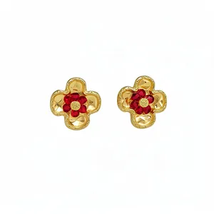 Vintage gold flower stud earrings with red crystal petals on a clean white background