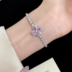Elegant close-up of a pink zircon clover flower bracelet worn on a female wrist