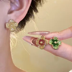 Macro view of vintage style Korean flower stud earrings with colorful stone petals on model