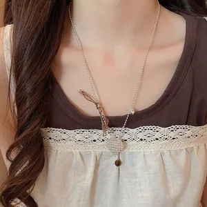 Elegant minimalist silver beaded heart pendant necklace worn on neck for fashion detail view
