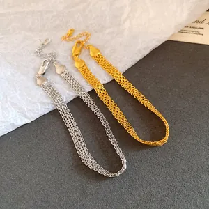 Close-up of elegant gold and silver layered link chain bracelets for stylish women