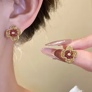 Elegant floral gradient stud earrings with retro gold-tone finish and crystal accents.