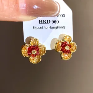 Detail of vintage-style gradient flower stud earrings with gold-toned border.