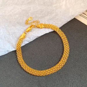 Detailed view of a gold-plated mesh chain bracelet with a secure lobster clasp.