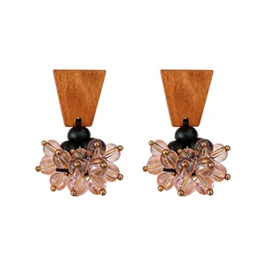 Vintage ethnic style earrings with brown wood and pink glass bead tassels, silver pins.