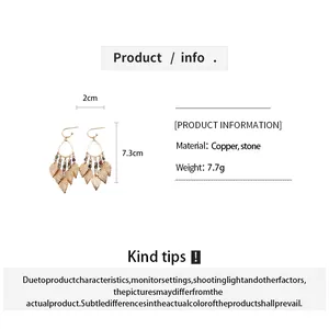 Close-up detail of ethnic leaf tassel drop earrings featuring copper and stone beads