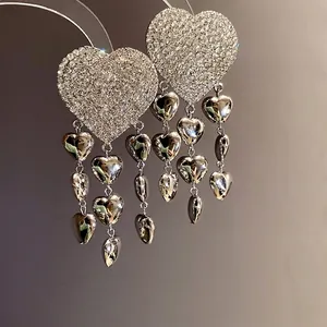 Luxury heart tassel earrings with sparkling rhinestones and a premium silver-tone finish.