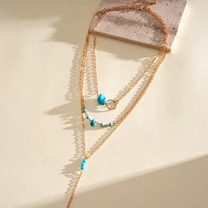 Detailed macro shot of a bohemian vintage gold multi-layer necklace with turquoise