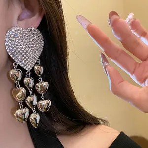 Oversized silver-tone rhinestone heart tassel earrings for a bold statement fashion look