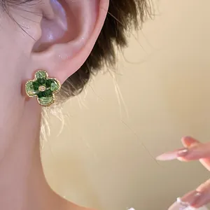 Close-up detail of Korean style green gradient flower stud earring worn by model