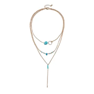 Retro gold-tone multi-layered necklace featuring geometric turquoise stone accents