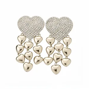 Elegant gold heart tassel earrings with sparkling pave crystals and dangling heart charms.