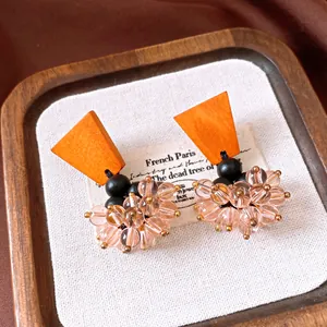 Macro detail view of vintage ethnic earrings with orange wood and pink glass beads