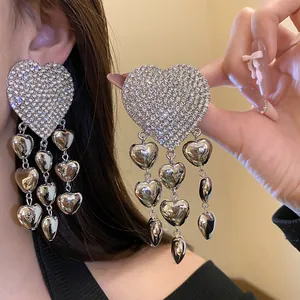Detailed view of luxury rhinestone heart earrings with elegant dangling heart tassels