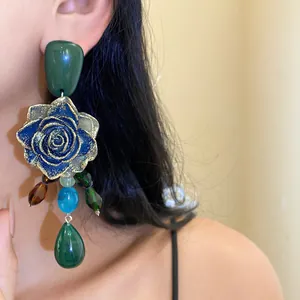 Detailed view of vintage resin flower earrings with colorful crystal teardrop pendants.