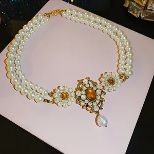 Vintage French luxury multi-layer pearl necklace with ornate gold-tone palace style pendant