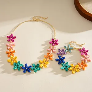 Close-up of colorful hand-woven raffia flower necklace and bracelet set for summer vacation.