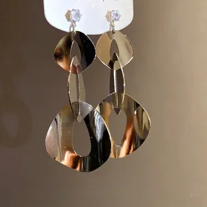 Elegant geometric metallic drop earrings with zircon accents and silver needle posts