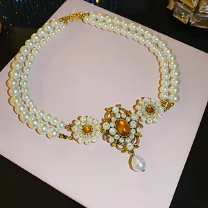 Detail of vintage French palace style multi-layer pearl necklace with amber pendant