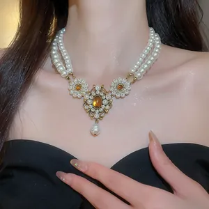 Detailed view of vintage French court style multi-layer pearl necklace with amber stones