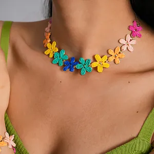 Close-up of a colorful raffia flower necklace for a vibrant summer vacation look.