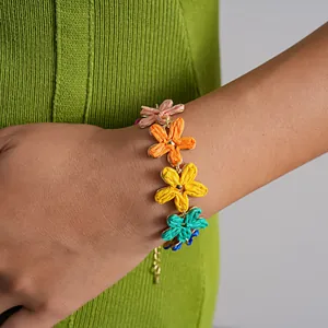 Detailed close-up of a colorful raffia flower bracelet for summer vacation beach wear