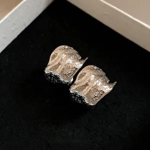 Elegant vintage silver-toned crumpled C-shape stud earrings with metallic texture